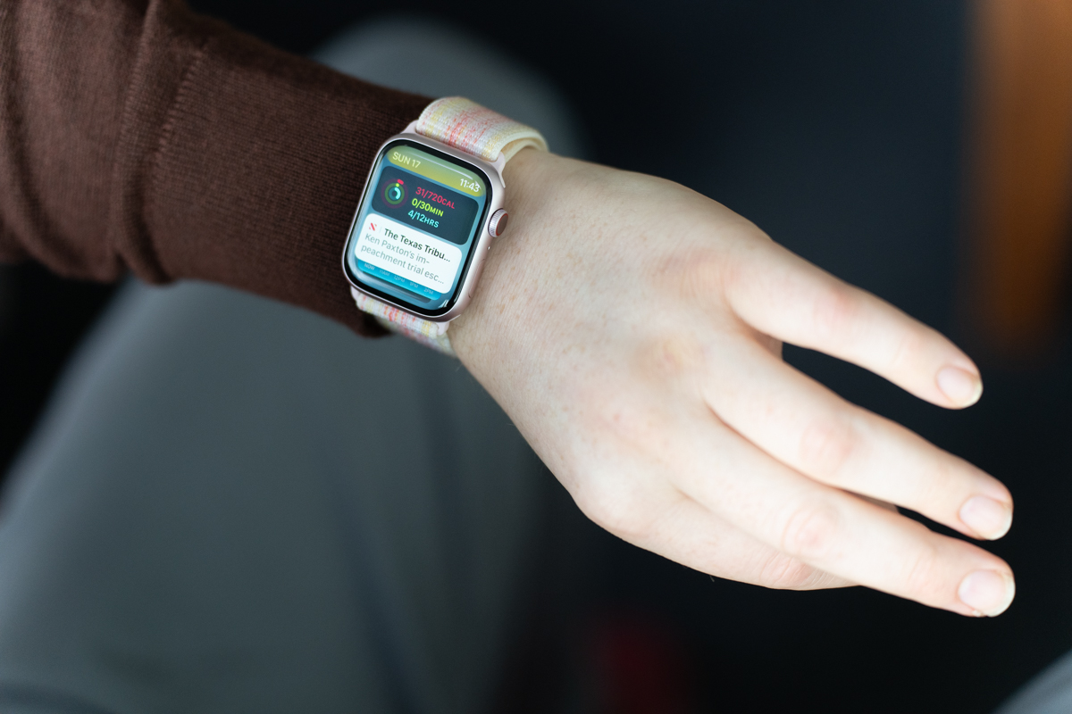 Apple Watch Series 9 in pink on a wrist, with the wearer using the new Double Tap feature