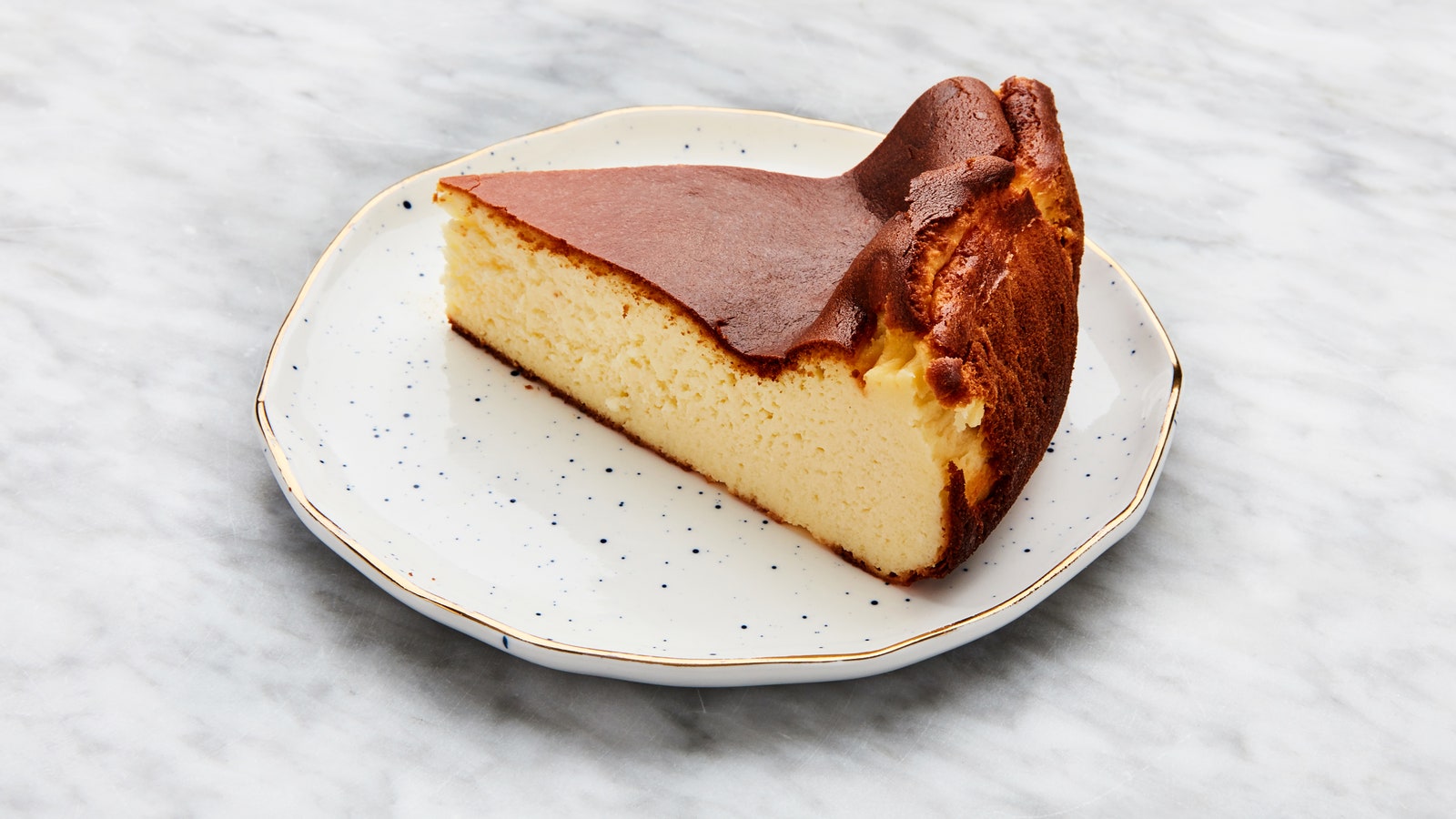 A slice of Basque cheesecake as seen from the side.